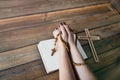 Womans hands with wooden rosary and Holy Bible Royalty Free Stock Photo