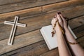 Womans hands with wooden rosary and Holy Bible Royalty Free Stock Photo