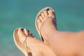 Womans legs at beach in summer