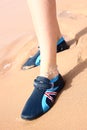 Womans legs in a shues on a beach sand Royalty Free Stock Photo