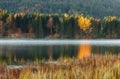 Womderful Autumn landscape. Road on meadow with grass on top view. Fairy Alpine lake Geroldsee with morning fog under sunlit. Royalty Free Stock Photo