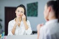 Womem in mirror clean make-up eyebrows Royalty Free Stock Photo
