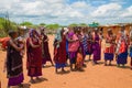 women from the African tribe Maasai in national dress in their village houses made of clay