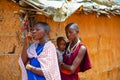 women from the African tribe Maasai in national dress in their village houses made of clay Royalty Free Stock Photo