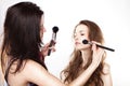 Women applying cosmetics Royalty Free Stock Photo