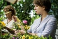 Women arranging flowers outdoor greenery Royalty Free Stock Photo