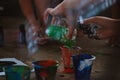 Women on art therapy mixing colors and painting on canvas with acrylic paints