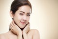 Women Asian beauty shot show her face good health on color warm gold background