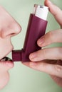 Women with asthmatic inhaler Royalty Free Stock Photo
