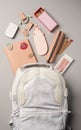 Women backpack and accessories on gray background