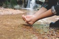 Women backpack and drinking water in river creek