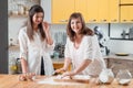 Women baking flattening dough home bake pastry