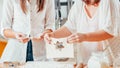 Women baking holding dough making biscuits