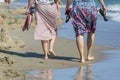 Women barefoot walk along the sea Royalty Free Stock Photo