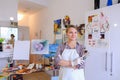 Women beautiful painter posing and smiling, laughing into camera