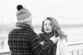 Man careing about woman on street. Man dressing black scarf on woman. Rouge woman with gray scarf Royalty Free Stock Photo