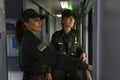 Women border guards in uniform standing in front of a window of a corridor of a passenger train. Grand Central train