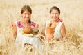 Women with bread at cereals field