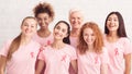 Women In Breast Cancer T-Shirts Standing Together Against Wall, Panorama