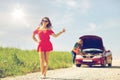 Women with broken car hitchhiking at countryside Royalty Free Stock Photo