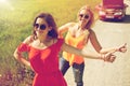 Women with broken car hitchhiking at countryside Royalty Free Stock Photo