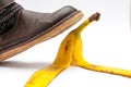 Women in brown leather shoe stepping on banana peel. Royalty Free Stock Photo