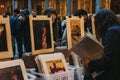 Women browse posters at second hand book market in the courtyard of the Vieille Bourse old stock exchange in Lille, France.