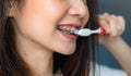 Women are brushing teeth that wear braces, in a toilet. Must maintain good oral health. Royalty Free Stock Photo