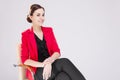 Women in Business. Portrait of Winsome Business Woman With Smile and red Suit jacket Posing Against White Royalty Free Stock Photo