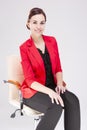 Women in Business. Portrait of Winsome Business Woman With Smile and red Suit jacket Posing Against White Royalty Free Stock Photo