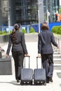 Women Business Travellers With Rolling Suitcases