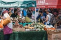 Women buy fresh fruits and vegetables from Brixton Market, London, UK