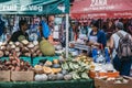 Women buy fresh fruits and vegetables from Brixton Market, London, UK