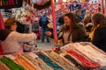 A Women Buying a Bag of Sweets at a Christmas Market.