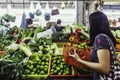 Women buying vegetables in wet market. women picking varieties of vegetables from retail stalls in the traditional market.