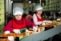 Women calibrating harvested apricots