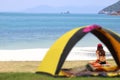 Teen girl in bikini camping and relaxing,Tent on the beach