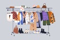 Women capsule wardrobe on racks. Fashion clothes on hanger rail. Autumn, winter apparels, shoes and accessories. Modern Royalty Free Stock Photo