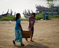 Women carrying goods on rural road in Mandalay, Myanmar Royalty Free Stock Photo