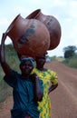 Women carrying pots on their heads in Burundi. Royalty Free Stock Photo