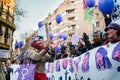 Barcelona, Spain - 8 march 2019: women chanting and calpping in the city during woman`s day with purple balloons