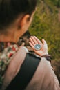 Women check direction at the compass in her hand to find right hiking path Royalty Free Stock Photo