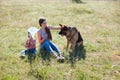 A woman with a child with German Shepherd training Royalty Free Stock Photo