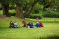 Women with children on the green lawn, Hannover, Lower Saxony, Germany. Copy space for text.