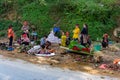 Women with children of the northern tribe of Vietnam sell bananas and flowers on the side of the road