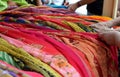 Women choosing colorul scarfs at indian market