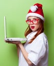 Women in christmas hat with white laptop computer Royalty Free Stock Photo