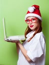 Women in christmas hat with white laptop computer Royalty Free Stock Photo