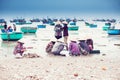 Women cleaning fish on the beach vietnam