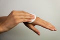 Women cleaning hands with cotton pad